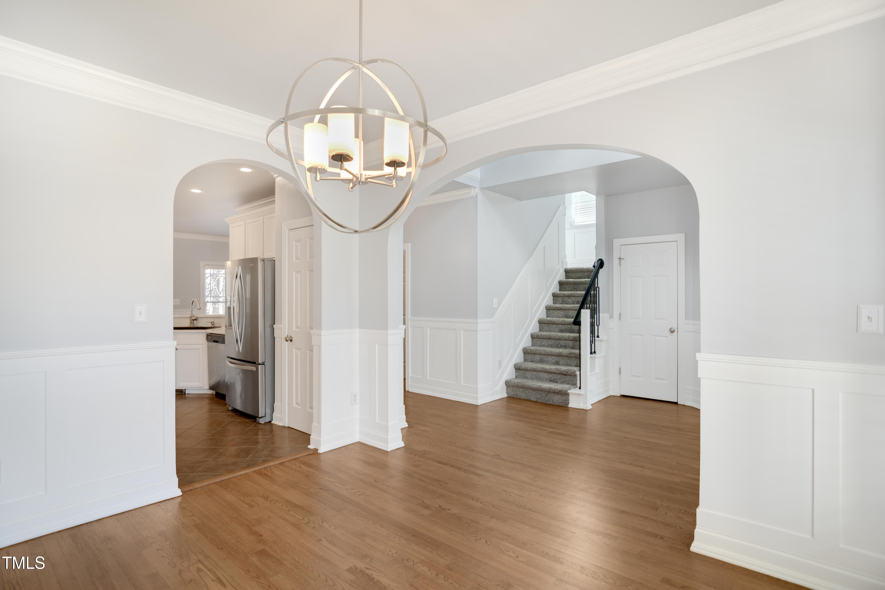 121 Homegate Circle Apex, NC 27502 - Photo 4 of 33 a view of a hallway with wooden floor and staircase