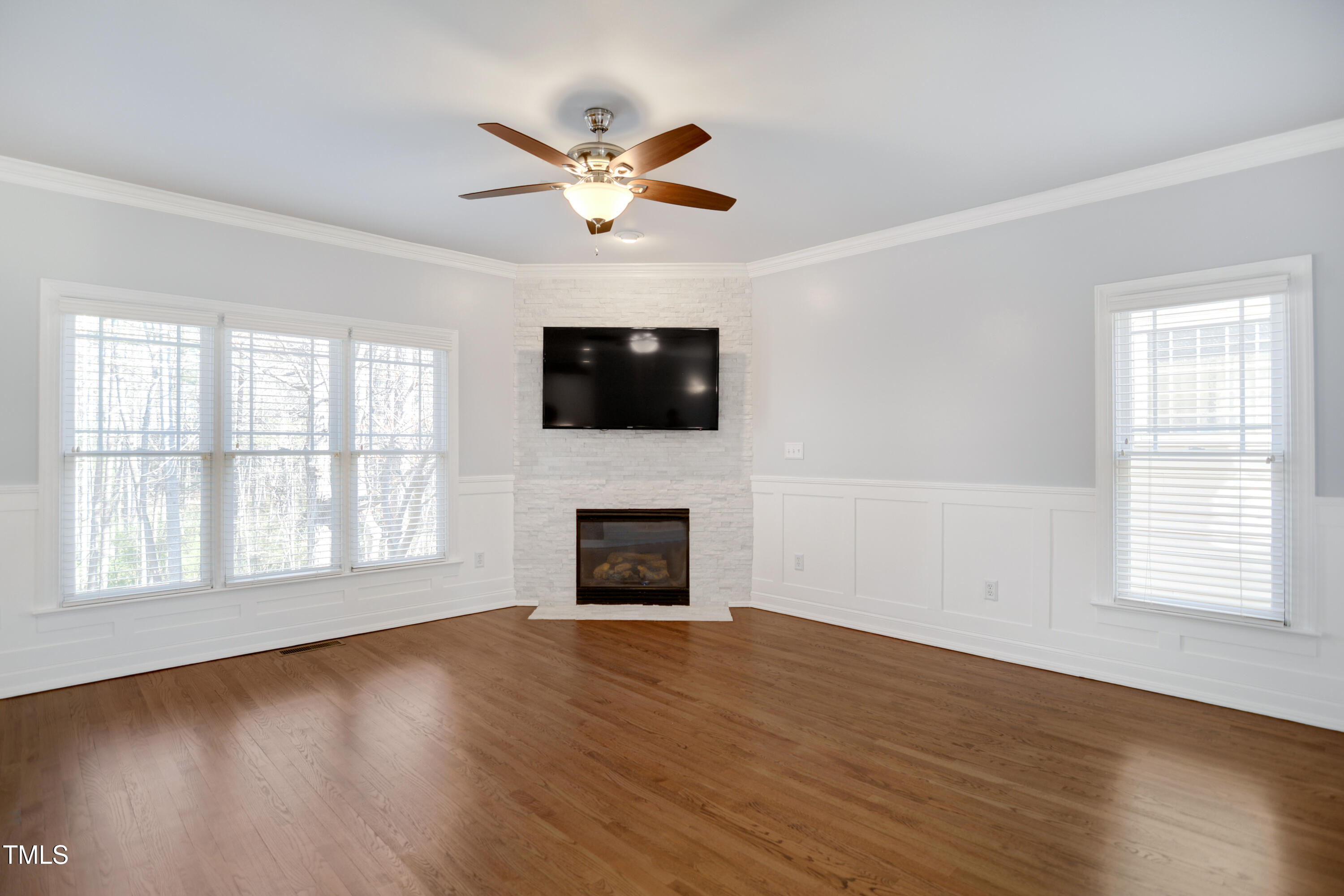 121 Homegate Circle Apex, NC 27502 - Photo 7 of 33 a view of an empty room with wooden floor and a window
