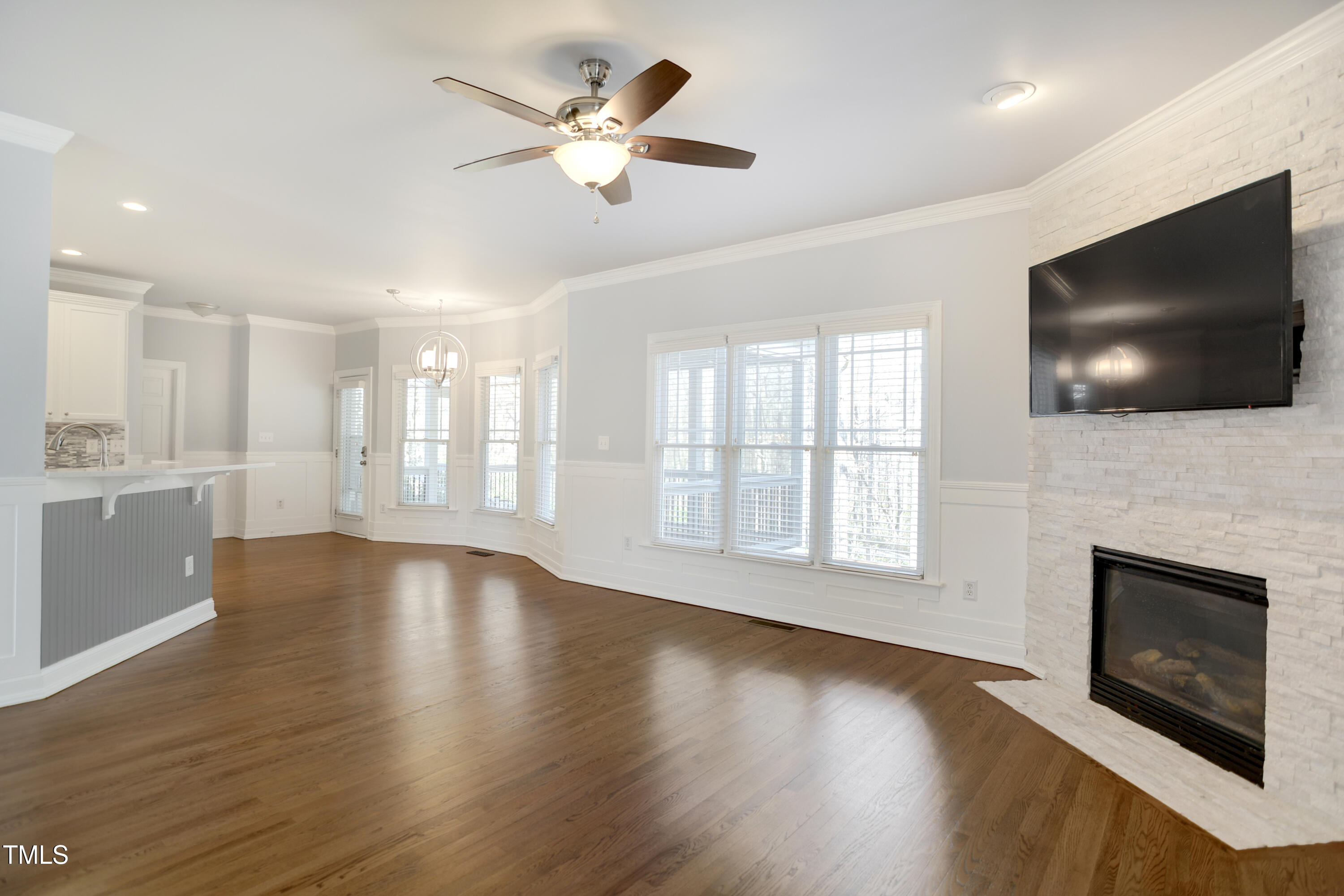 121 Homegate Circle Apex, NC 27502 - Photo 8 of 33 wooden floor fireplace and windows in an empty room