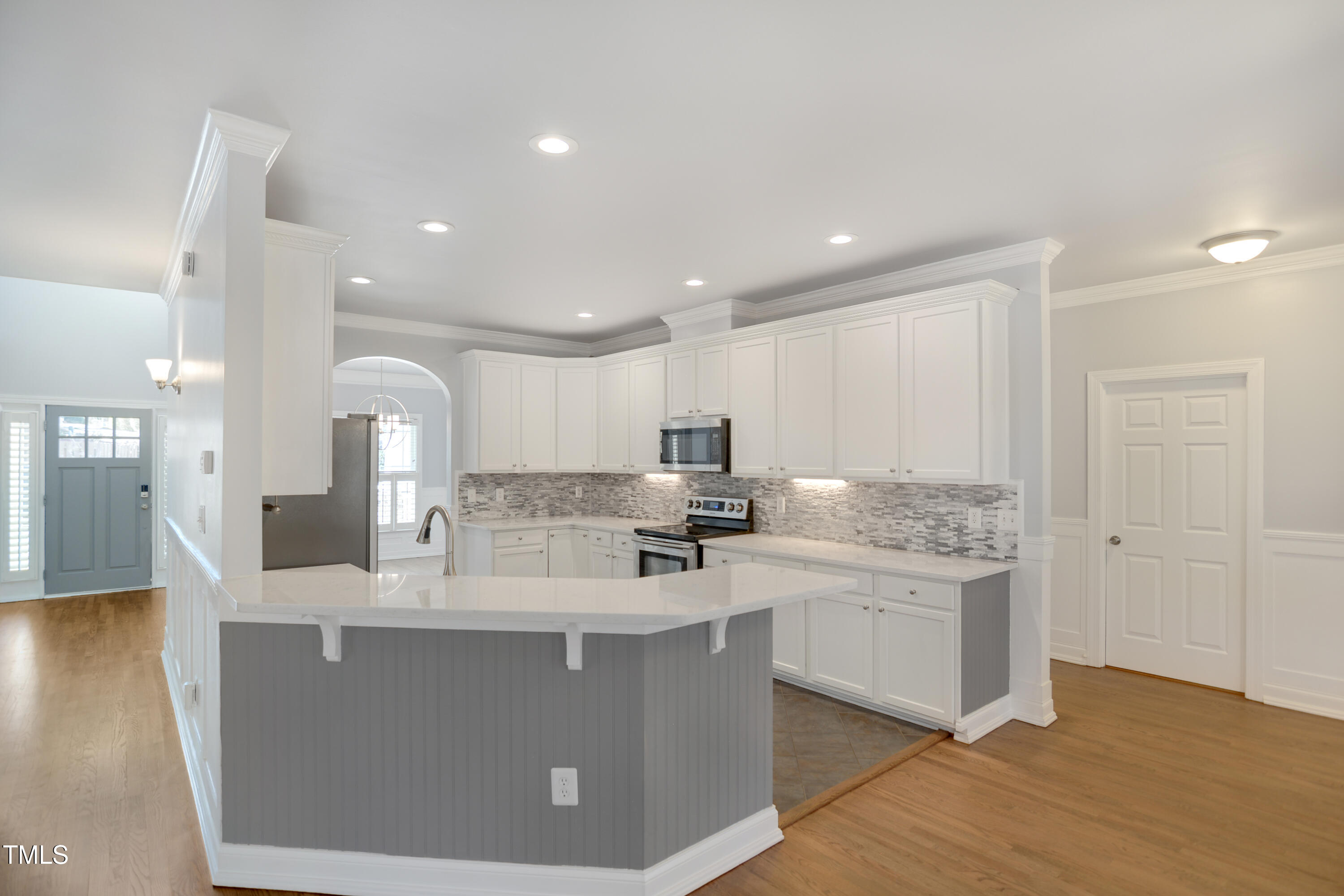 121 Homegate Circle Apex, NC 27502 - Photo 9 of 33 a kitchen with stainless steel appliances granite countertop a sink a stove and a refrigerator