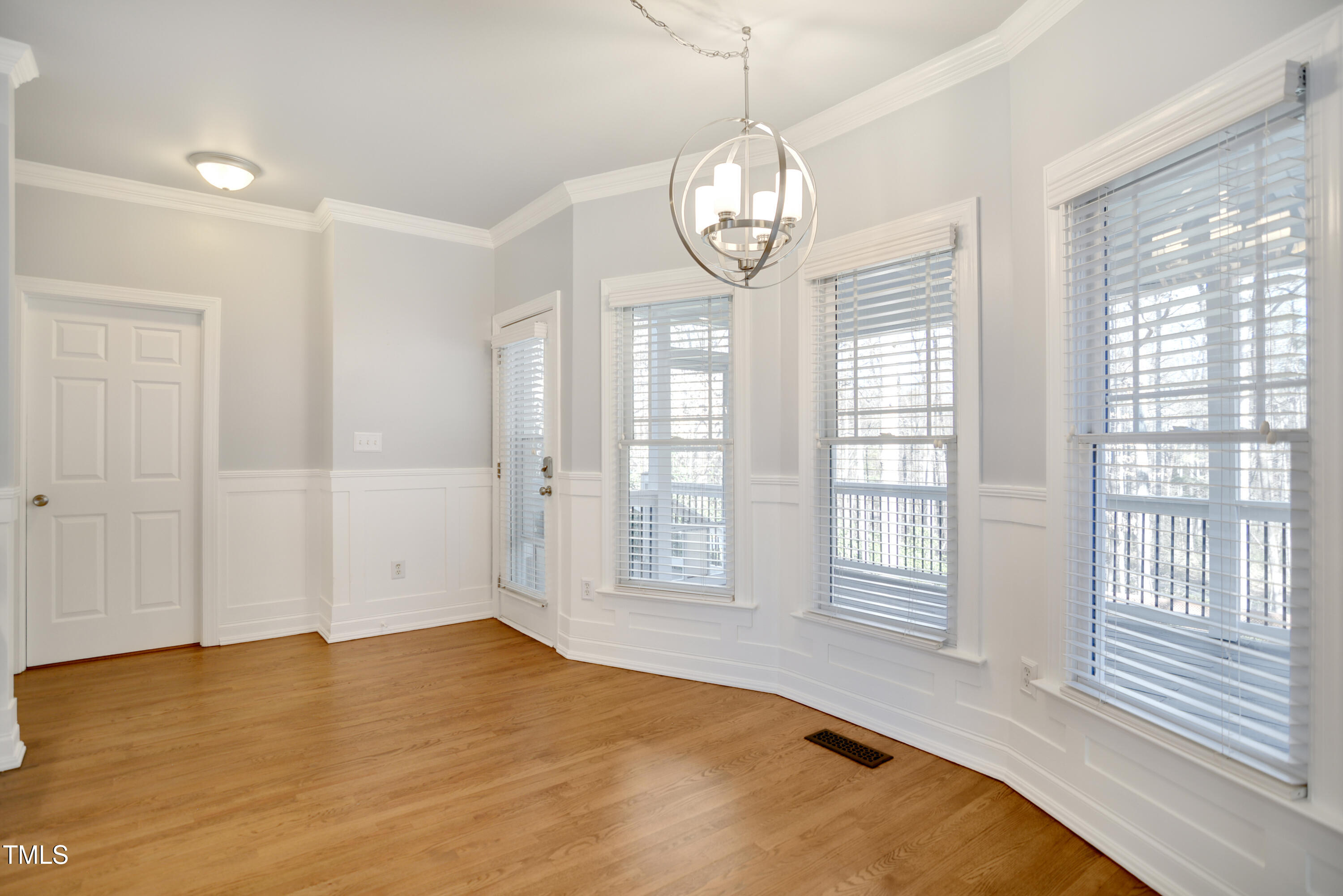 121 Homegate Circle Apex, NC 27502 - Photo 10 of 33 a view of empty room with wooden floor and fan