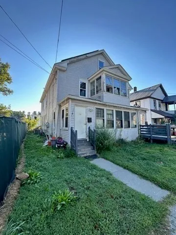 a front view of a house with a yard and porch