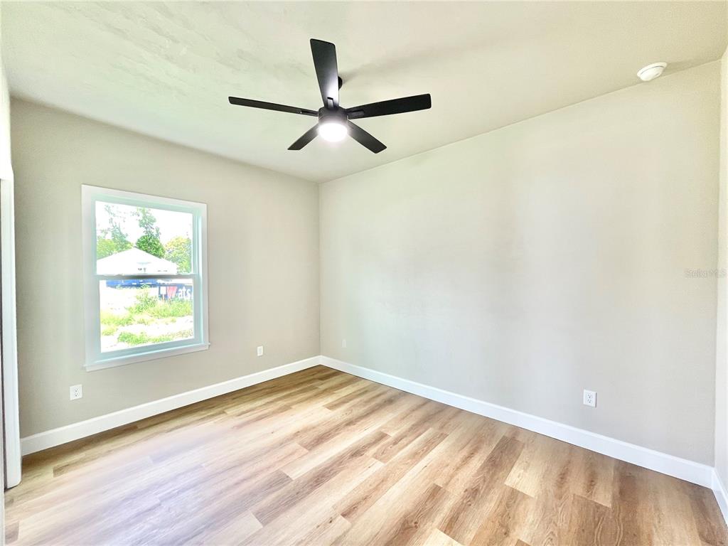 1021 Southwest 67th Street Gainesville, FL 32607 - Photo 24 of 53 a view of a big room with wooden floor and windows