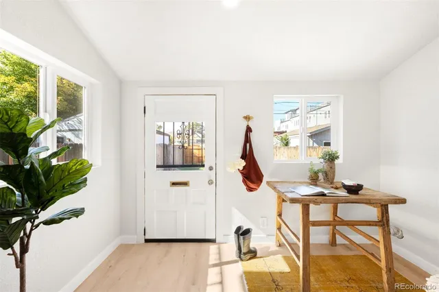 a view of a livingroom with furniture and a potted plant
