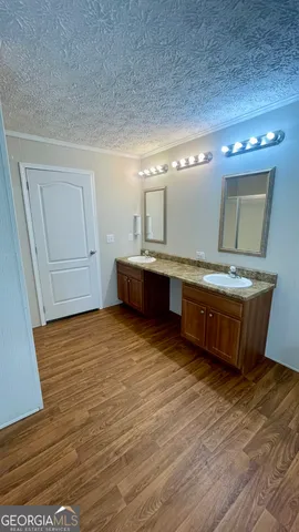 a room with wooden floors and cabinet