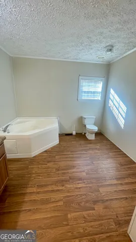 a bathroom with a bathtub and a window