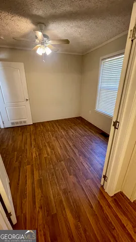 a view of an empty room and wooden floor