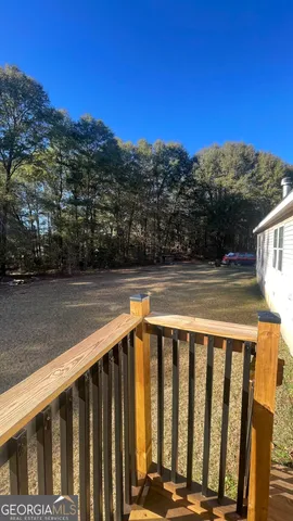 a view of wooden fence and a yard