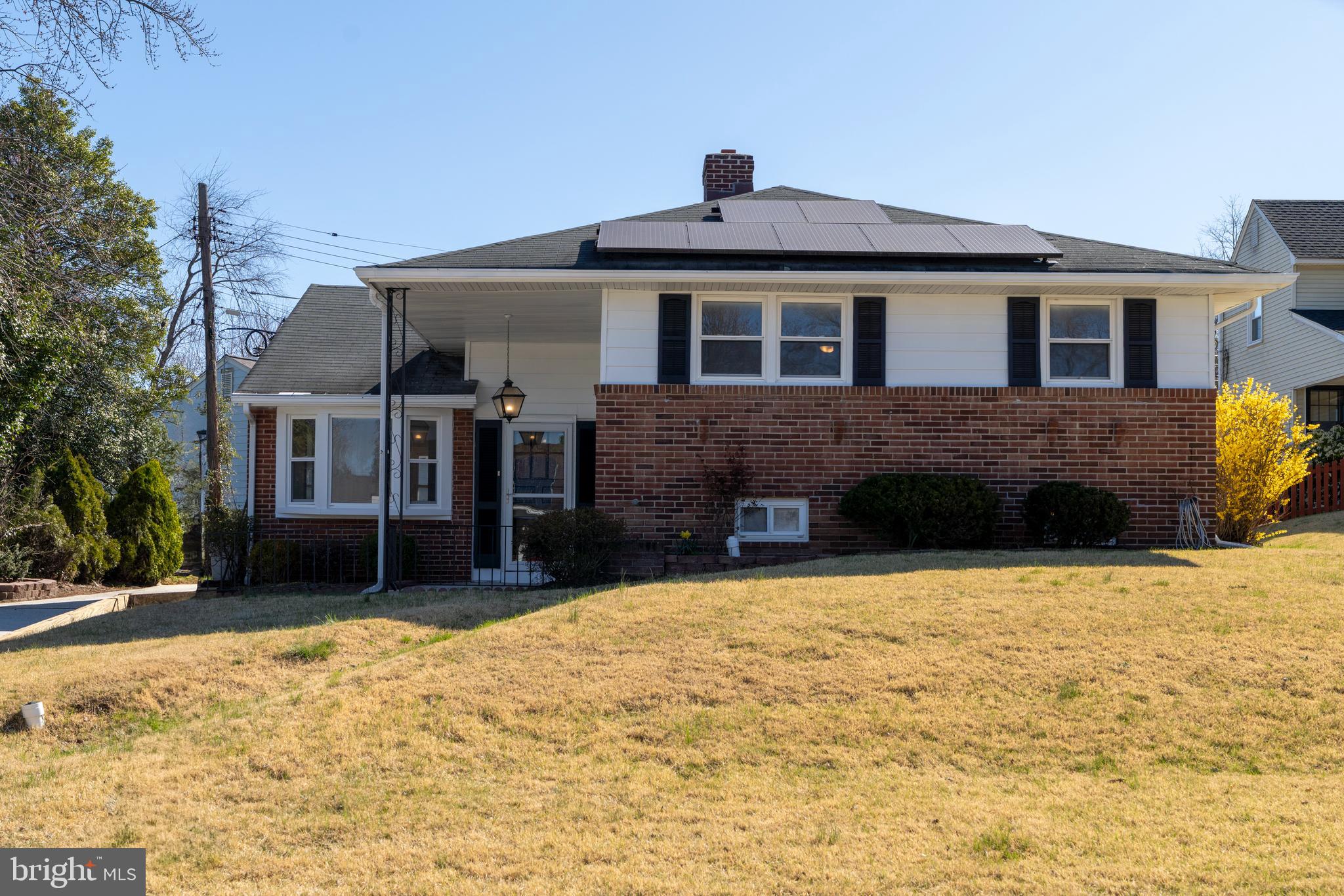 a front view of a house with a yard covered in snow