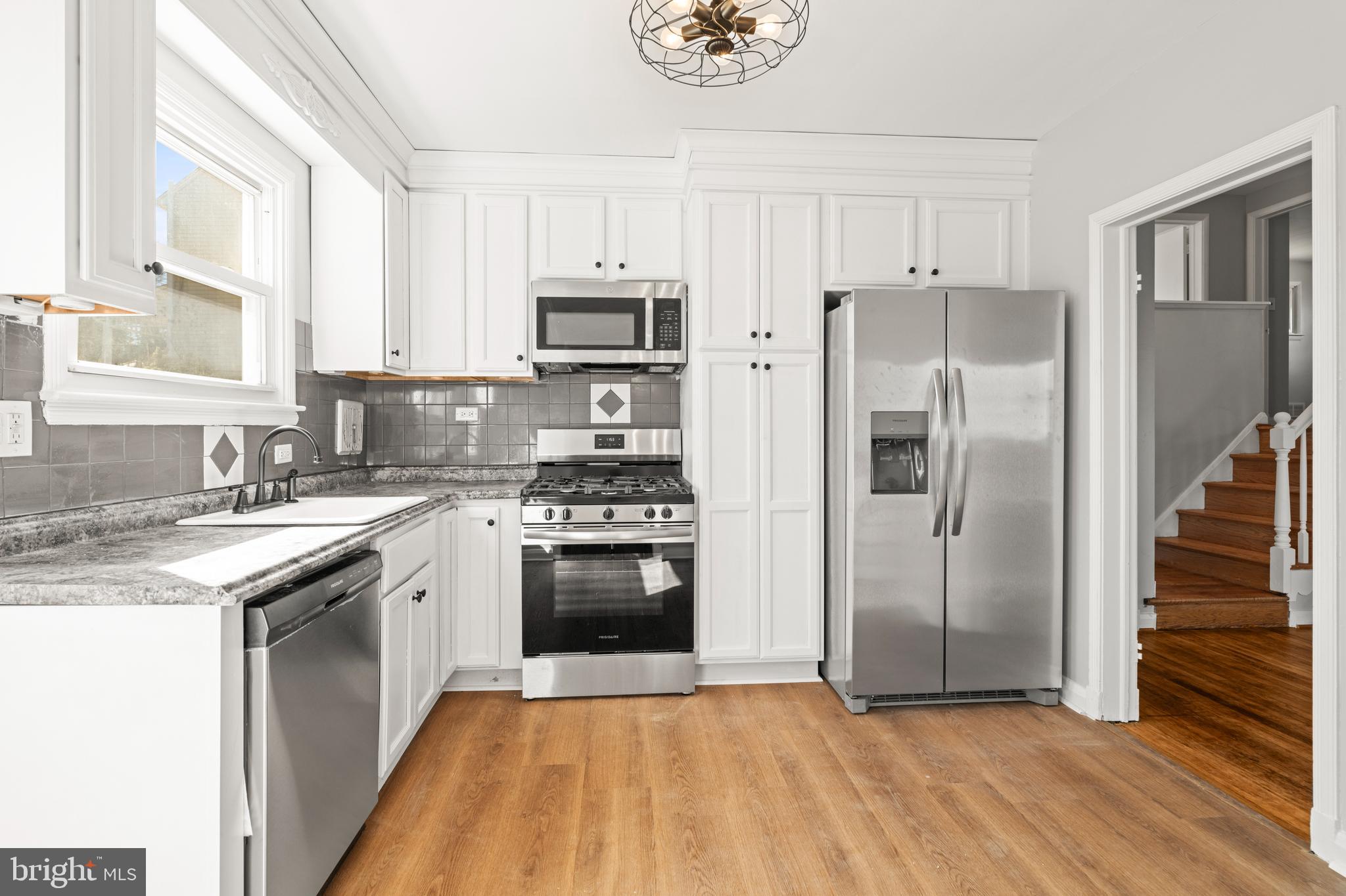 1407 Shefford Road Baltimore, MD 21239 - Photo 11 of 35 a kitchen with stainless steel appliances granite countertop a refrigerator stove and sink
