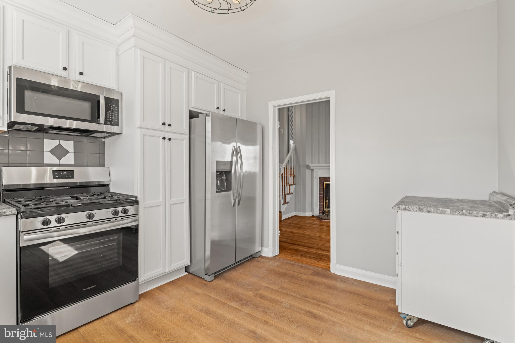 1407 Shefford Road Baltimore, MD 21239 - Photo 12 of 35 a kitchen with a stove top oven and refrigerator
