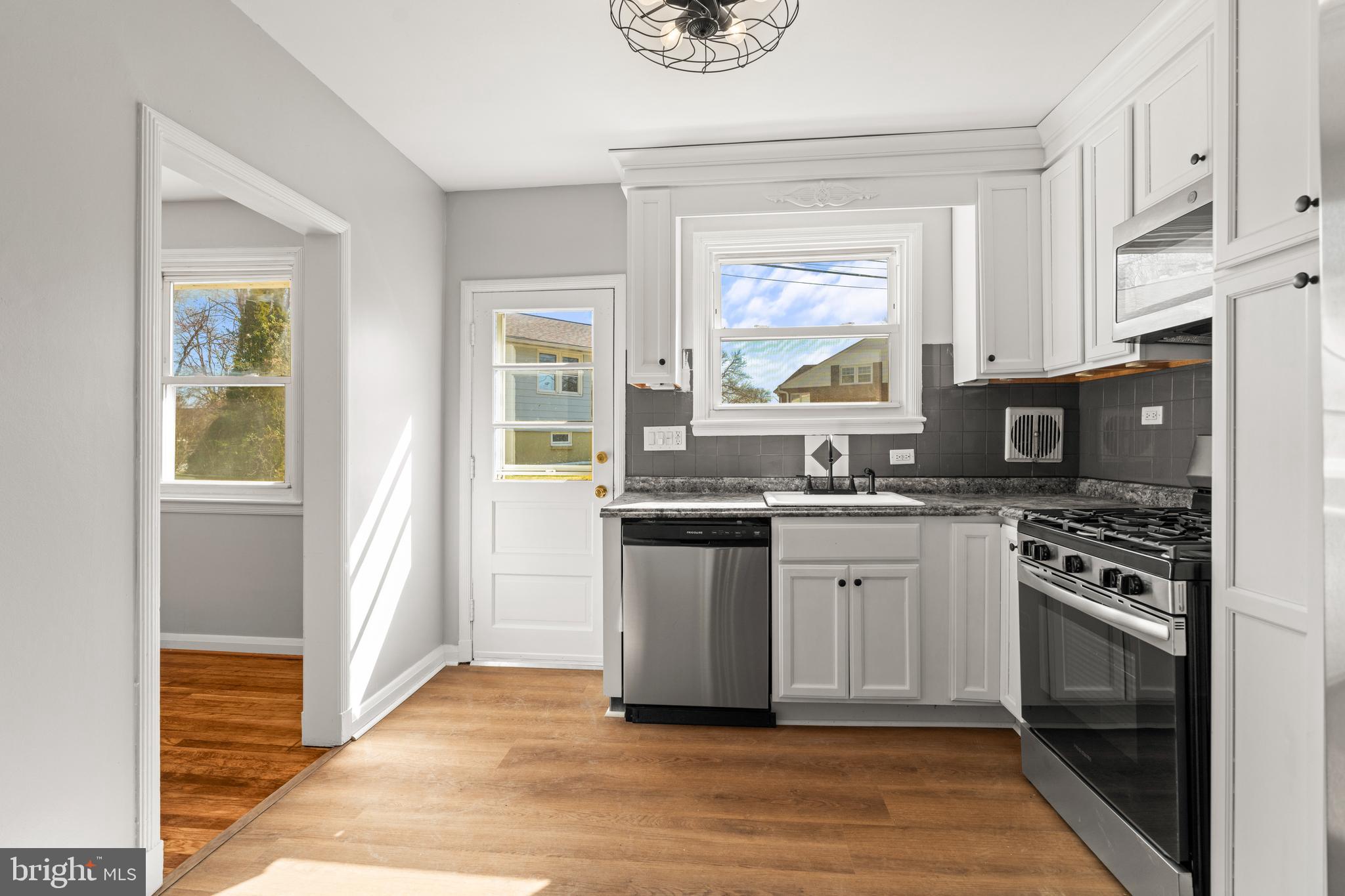 1407 Shefford Road Baltimore, MD 21239 - Photo 13 of 35 a kitchen with stainless steel appliances granite countertop a stove a sink and a refrigerator