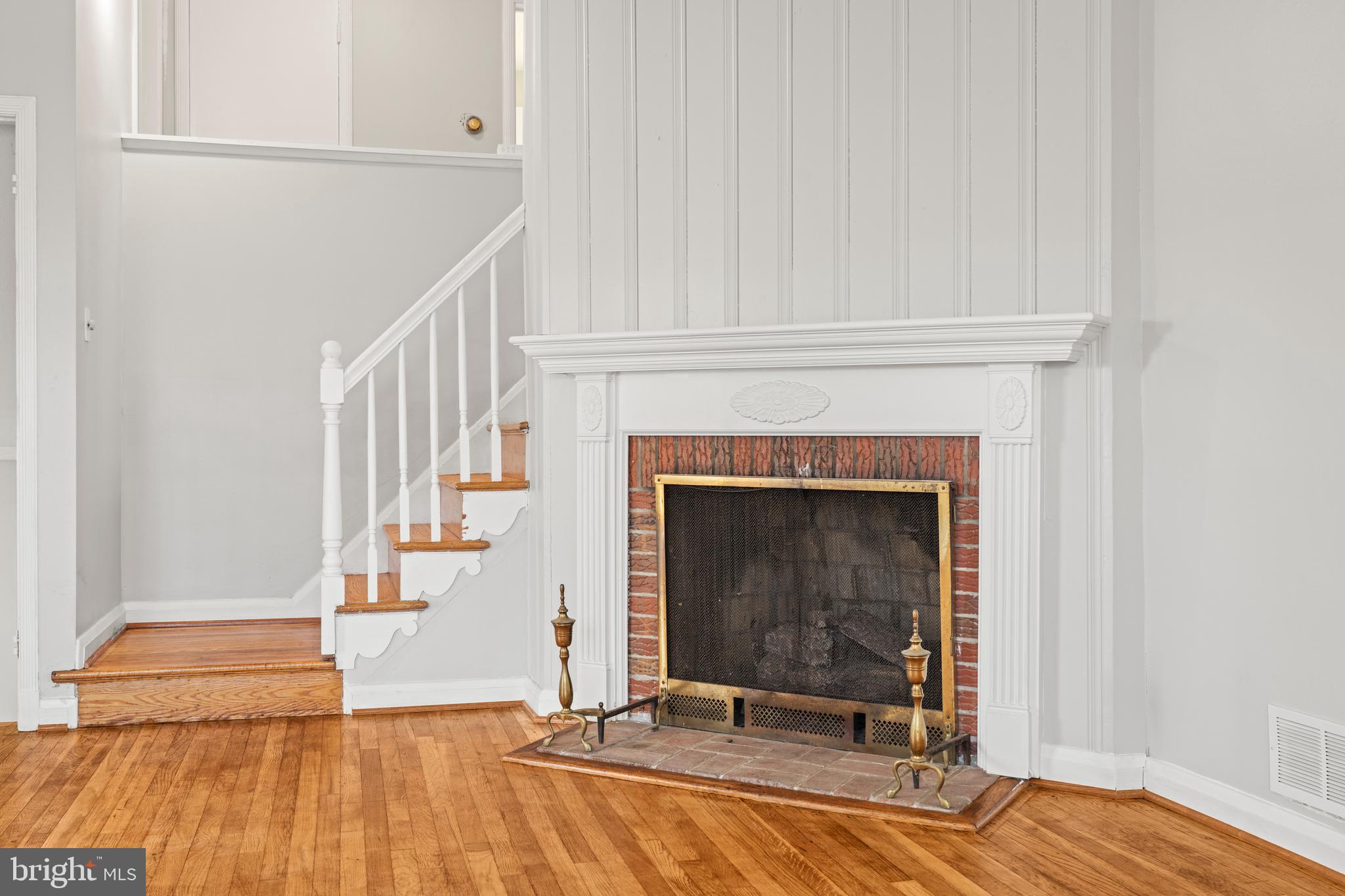 1407 Shefford Road Baltimore, MD 21239 - Photo 14 of 35 a view of a livingroom with wooden floor and a fireplace