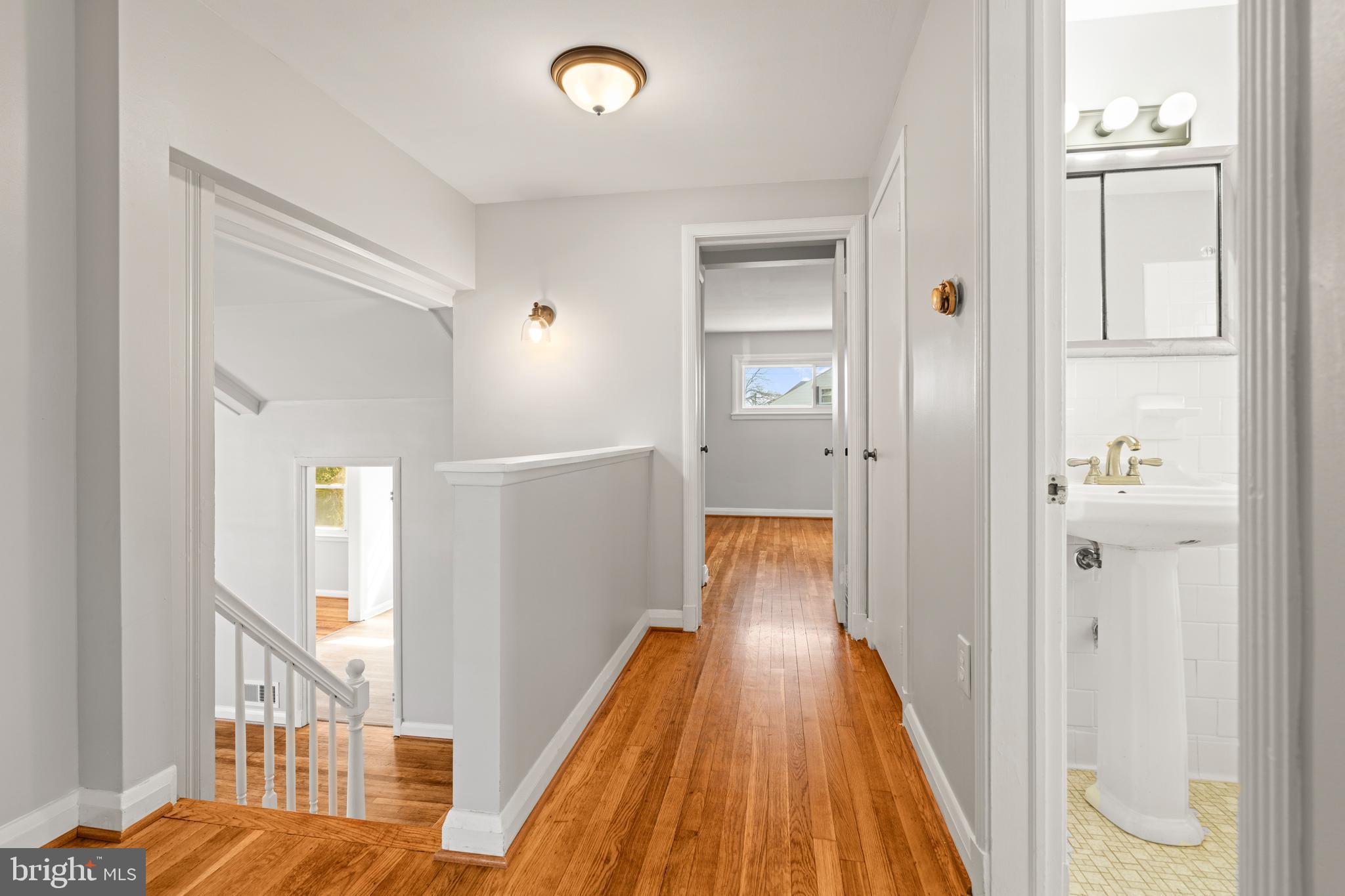1407 Shefford Road Baltimore, MD 21239 - Photo 15 of 35 a view of a hallway with wooden floor and staircase