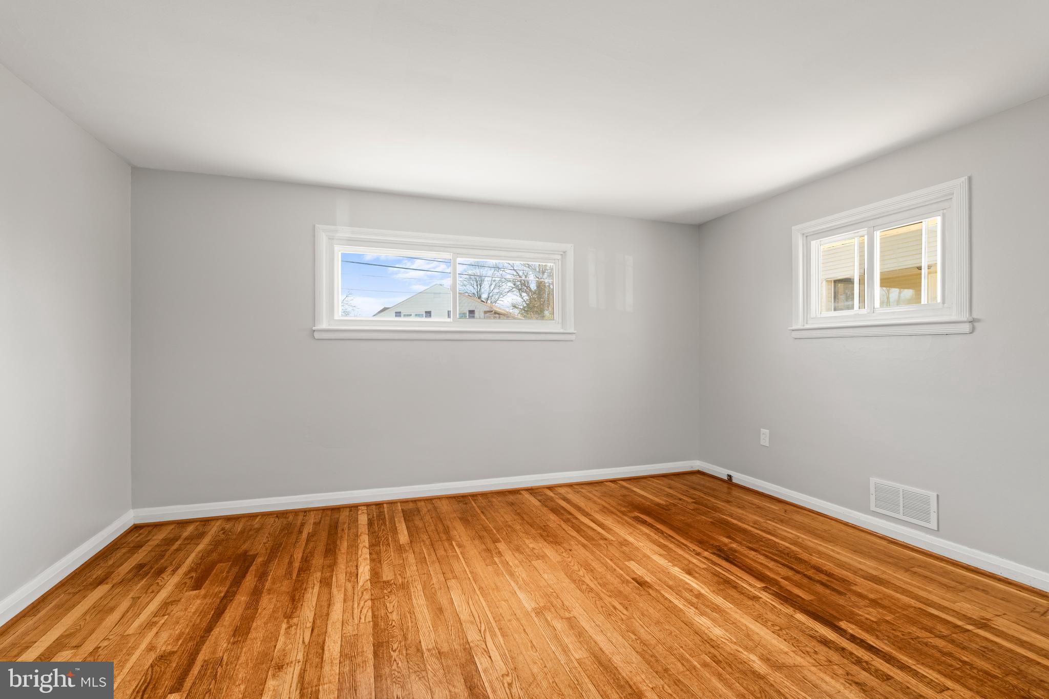 1407 Shefford Road Baltimore, MD 21239 - Photo 17 of 35 a view of empty room with wooden floor