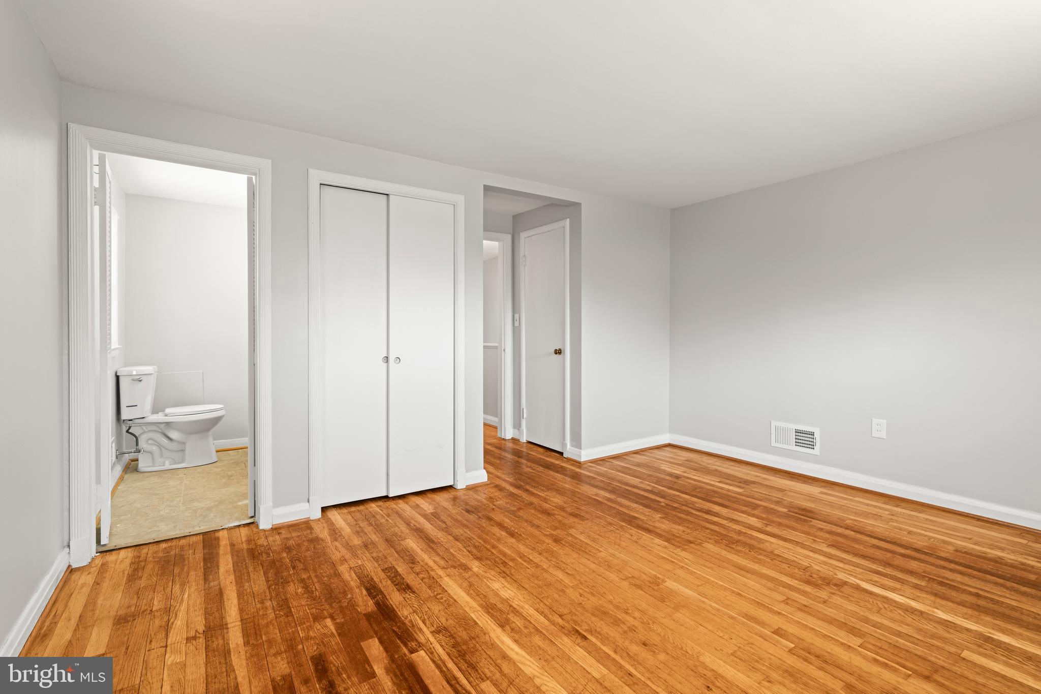 1407 Shefford Road Baltimore, MD 21239 - Photo 18 of 35 a bedroom with a bed and a table