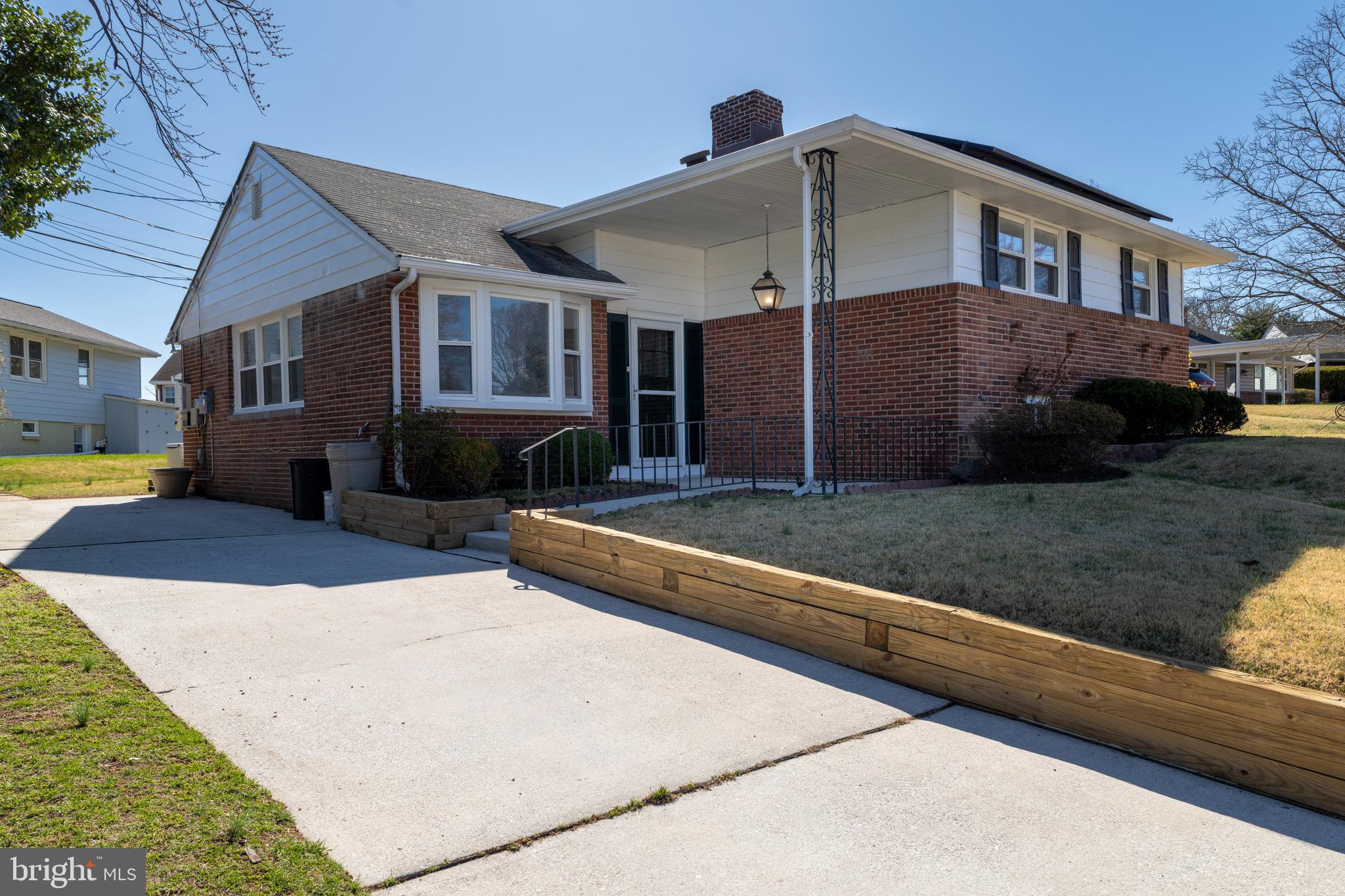1407 Shefford Road Baltimore, MD 21239 - Photo 2 of 35 a front view of a house with a yard