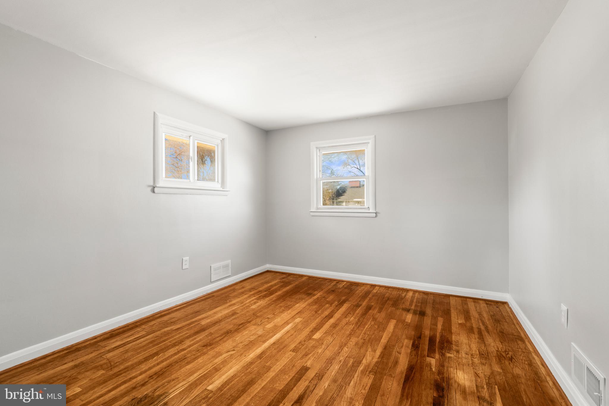 1407 Shefford Road Baltimore, MD 21239 - Photo 23 of 35 a view of empty room with wooden floor