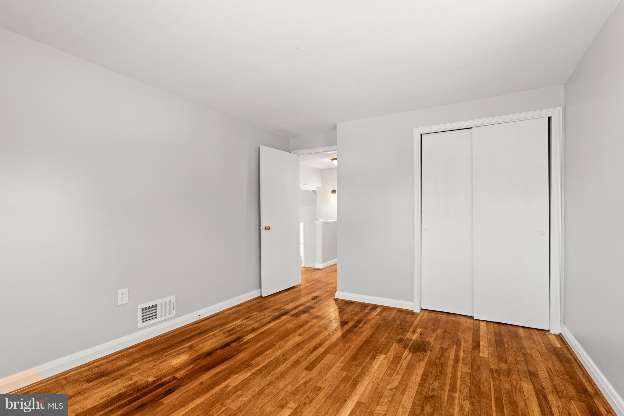 1407 Shefford Road Baltimore, MD 21239 - Photo 24 of 35 a view of empty room with wooden floor