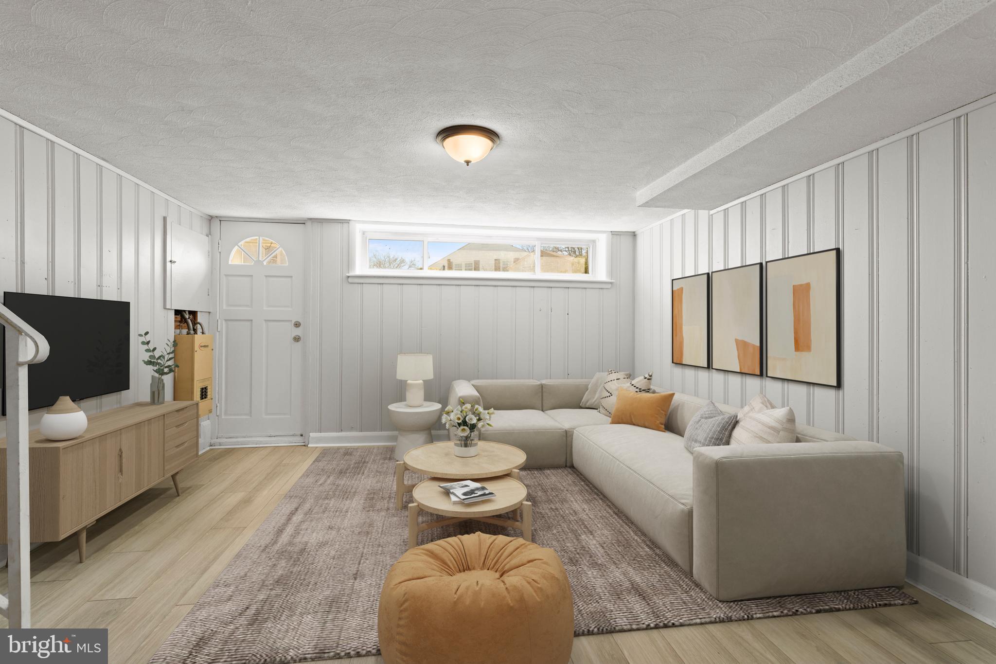 1407 Shefford Road Baltimore, MD 21239 - Photo 25 of 35 a living room with furniture and a flat screen tv