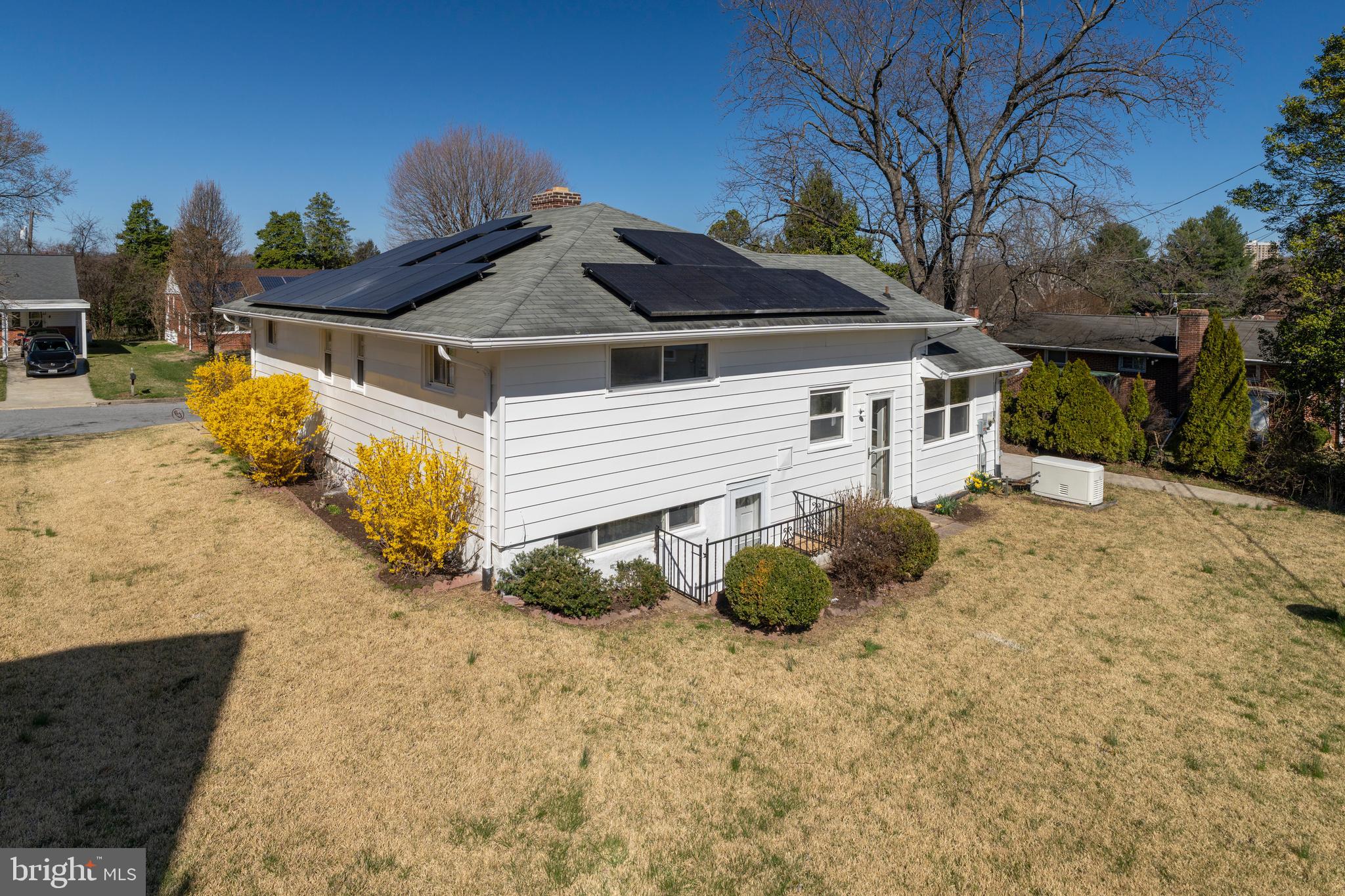 1407 Shefford Road Baltimore, MD 21239 - Photo 28 of 35 a white house with a large tree in front of it