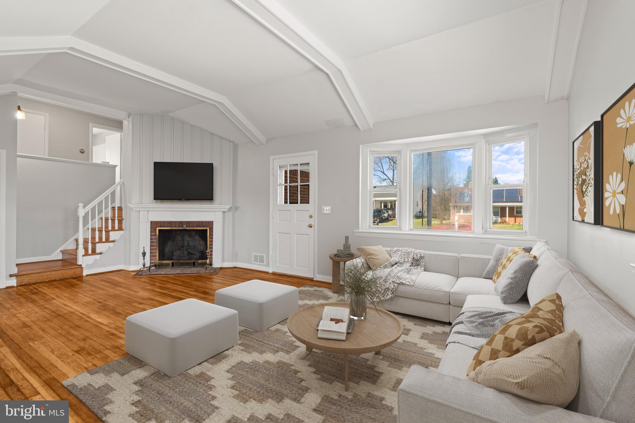1407 Shefford Road Baltimore, MD 21239 - Photo 5 of 35 a living room with furniture a fireplace and a flat screen tv