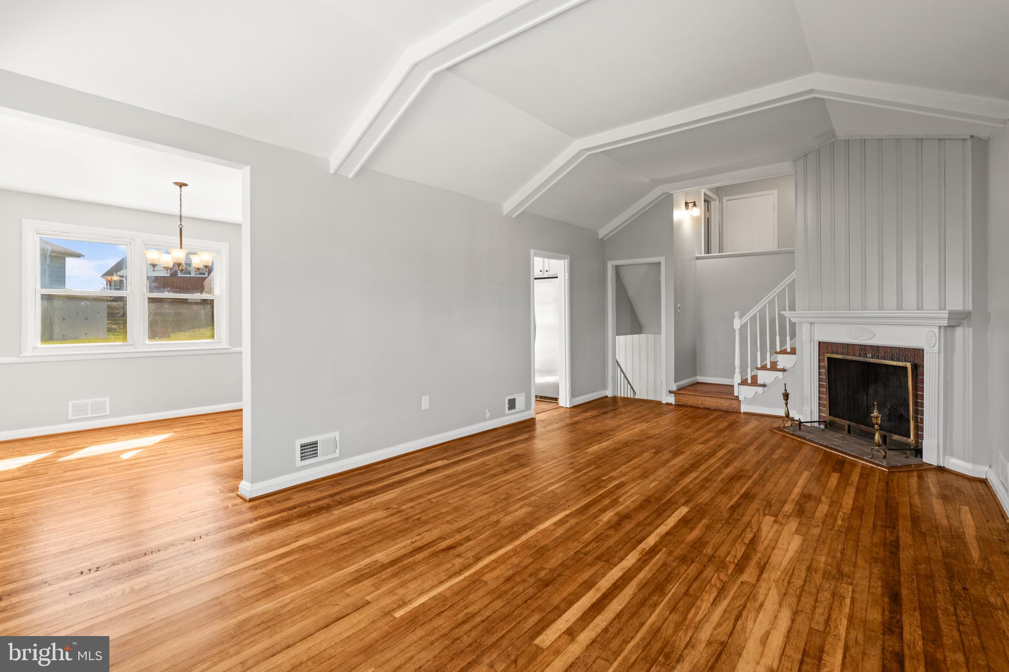 1407 Shefford Road Baltimore, MD 21239 - Photo 34 of 35 a view of a livingroom with wooden floor and a fireplace