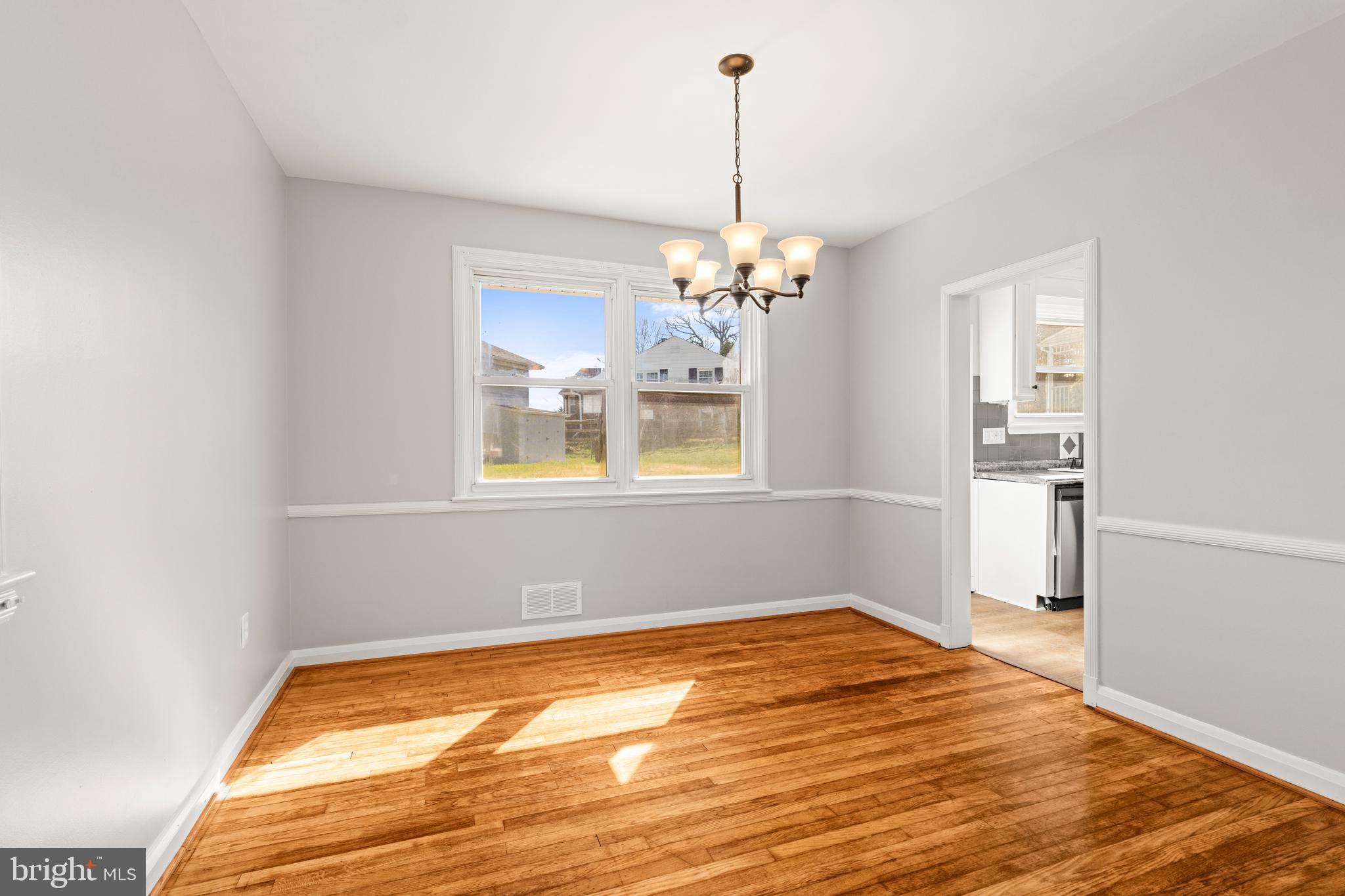 1407 Shefford Road Baltimore, MD 21239 - Photo 9 of 35 a view of empty room with wooden floor