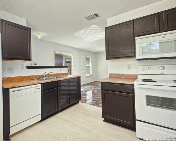 a kitchen with stainless steel appliances a stove microwave and cabinets