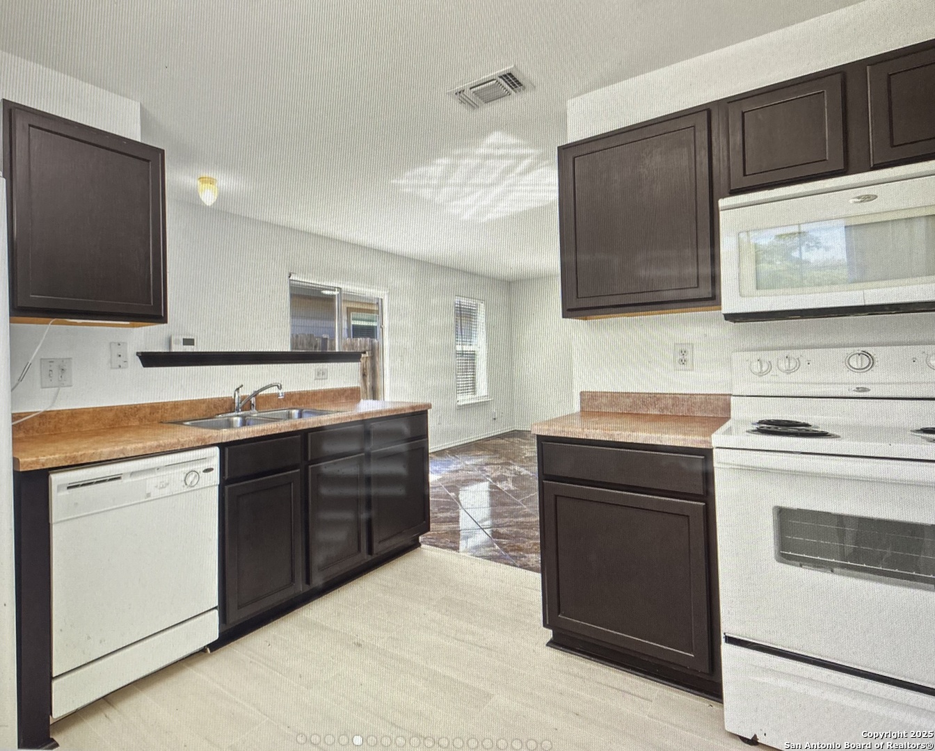 a kitchen with stainless steel appliances a stove microwave and cabinets