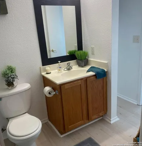 a bathroom with a toilet sink and mirror