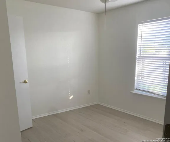 a view of a backyard with wooden fence