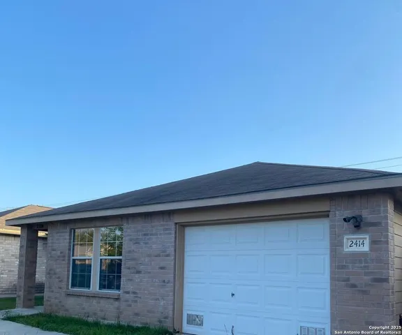 a front view of a house with a plants