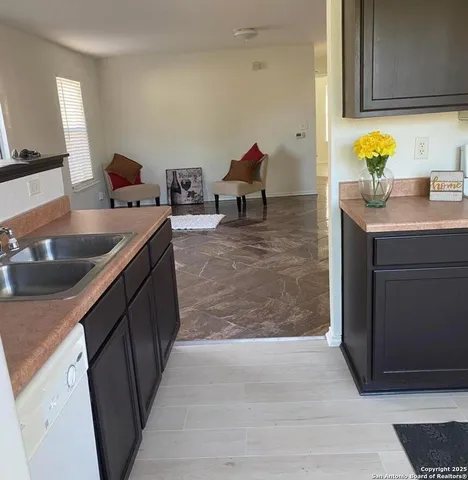 a kitchen with a sink and a refrigerator