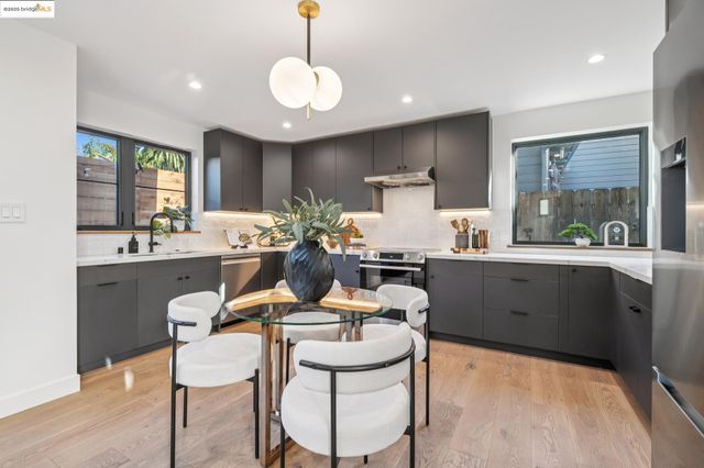 a kitchen with a refrigerator and a stove