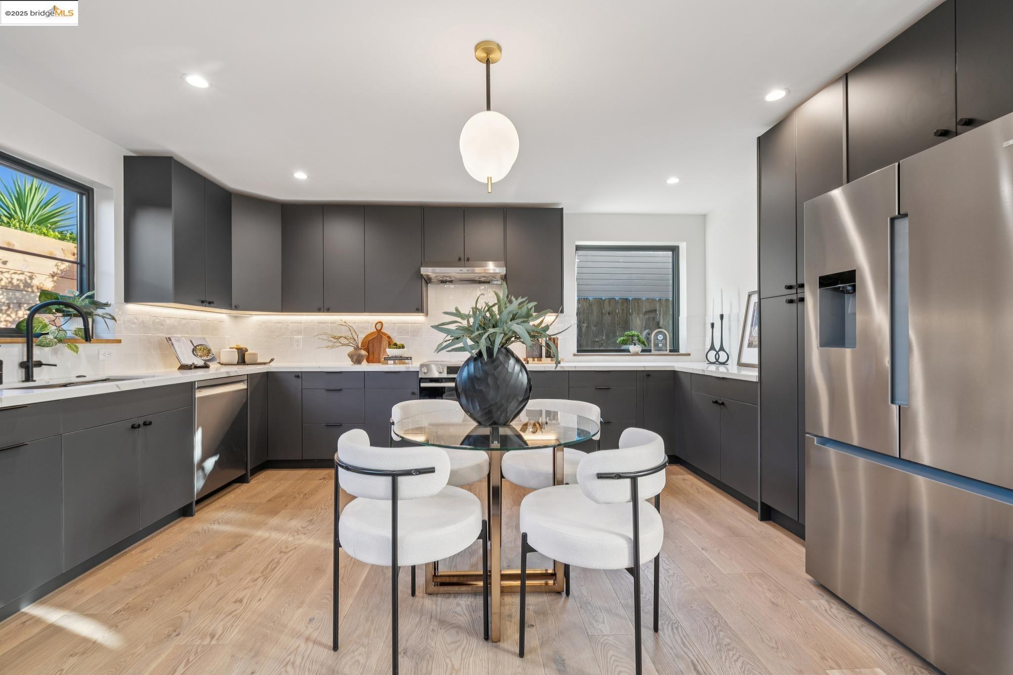 1516 A Blake Street Berkeley, CA 94703 - Photo 15 of 55 a kitchen with a refrigerator a sink dishwasher with a dining table and chairs