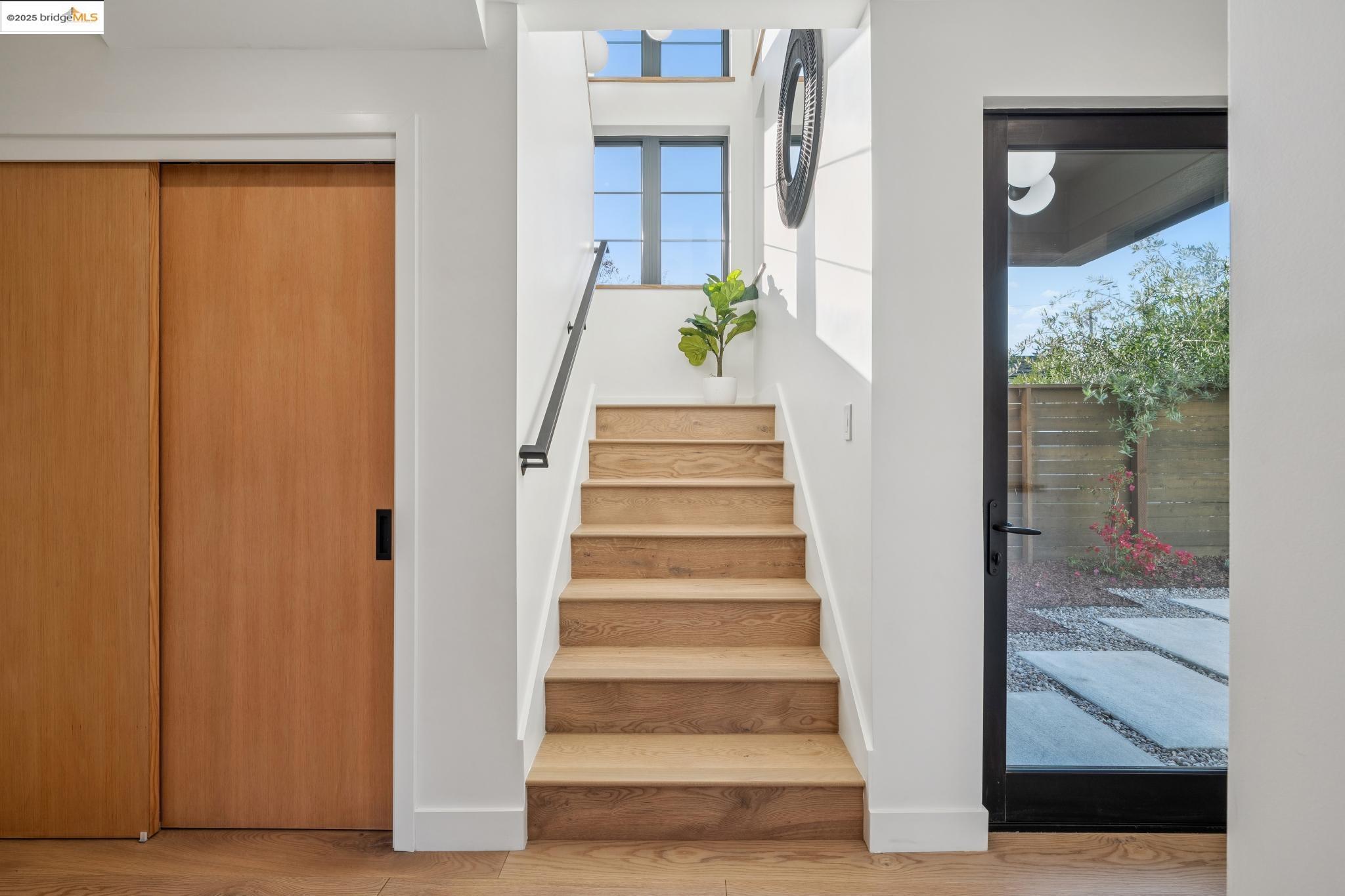 1516 A Blake Street Berkeley, CA 94703 - Photo 30 of 55 a view of a staircase with wooden floor and a potted plant