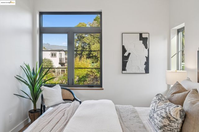 a bed sitting in a bedroom next to a window