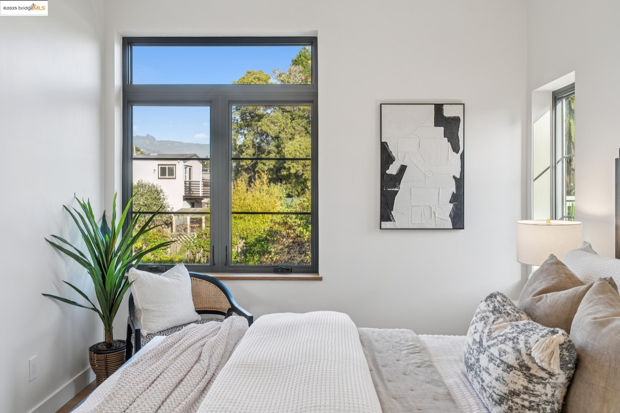 1516 A Blake Street Berkeley, CA 94703 - Photo 39 of 55 a bedroom with a large window and a potted plant