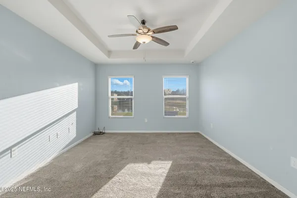 a view of room with window and ceiling fan