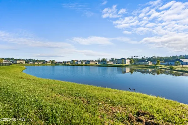 a view of a lake with houses in the back