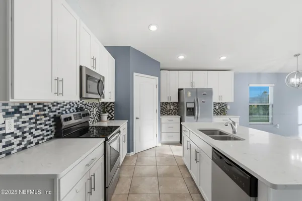 a kitchen with a sink stove and refrigerator