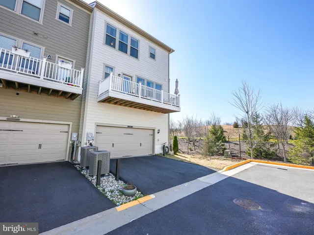 a view of a house with pool and sitting area