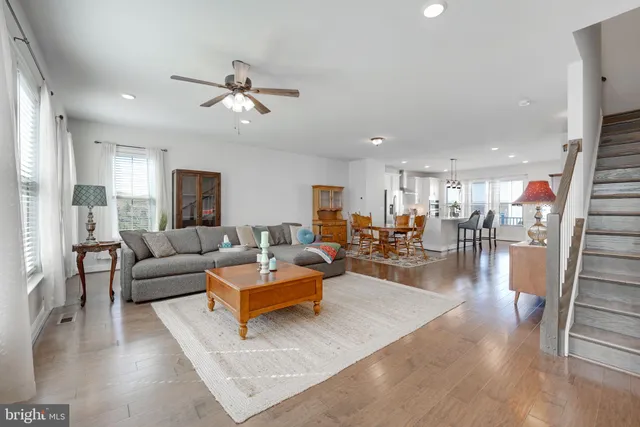 a kitchen with counter top space wooden floor and stainless steel appliances