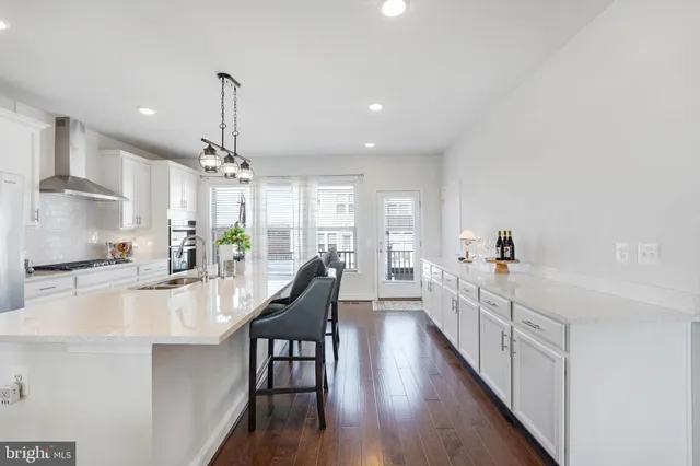 a kitchen with granite countertop a stove and a sink