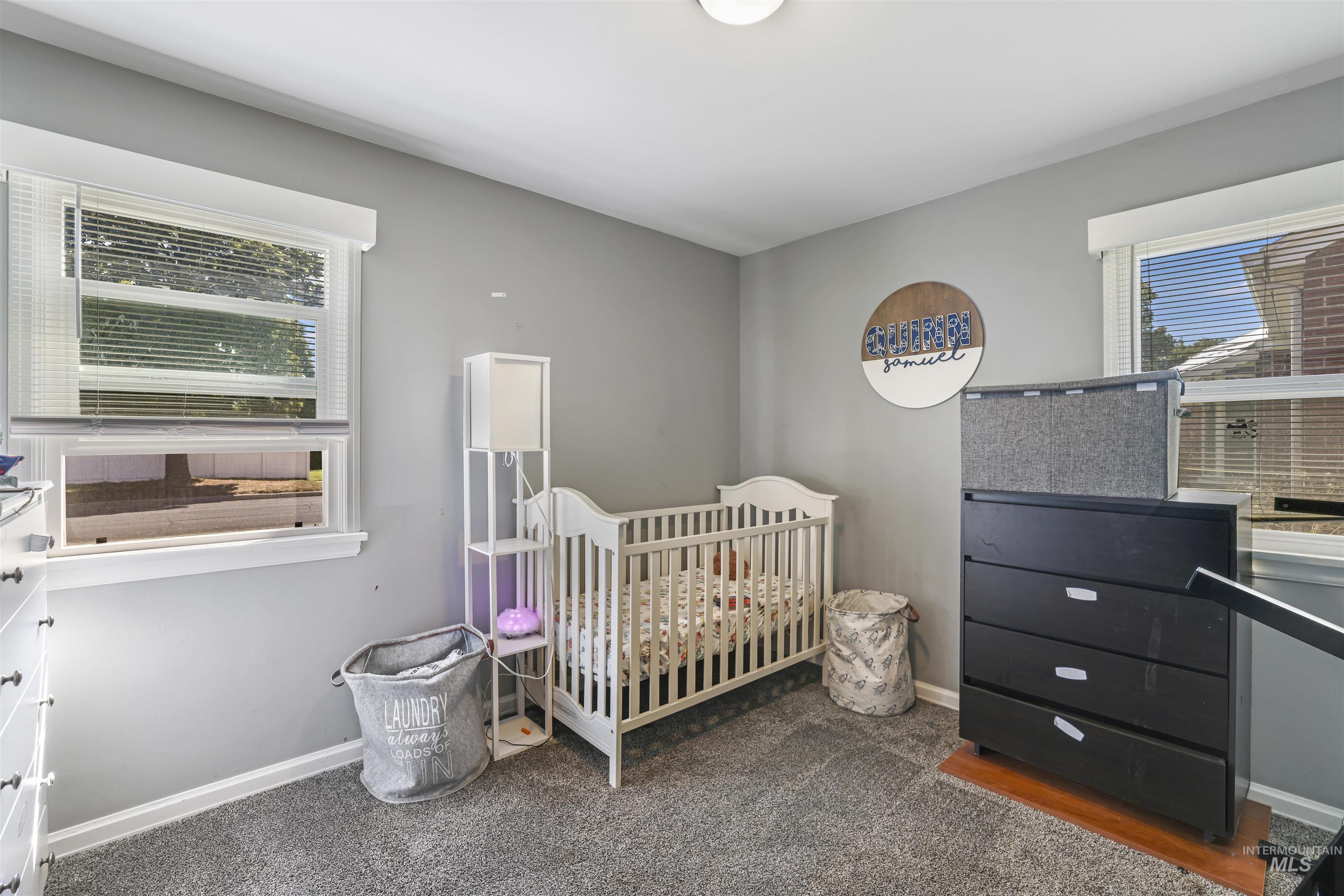 201 West 19th Street Burley, ID 83318 - Photo 22 of 31 Bedroom with a crib and carpet