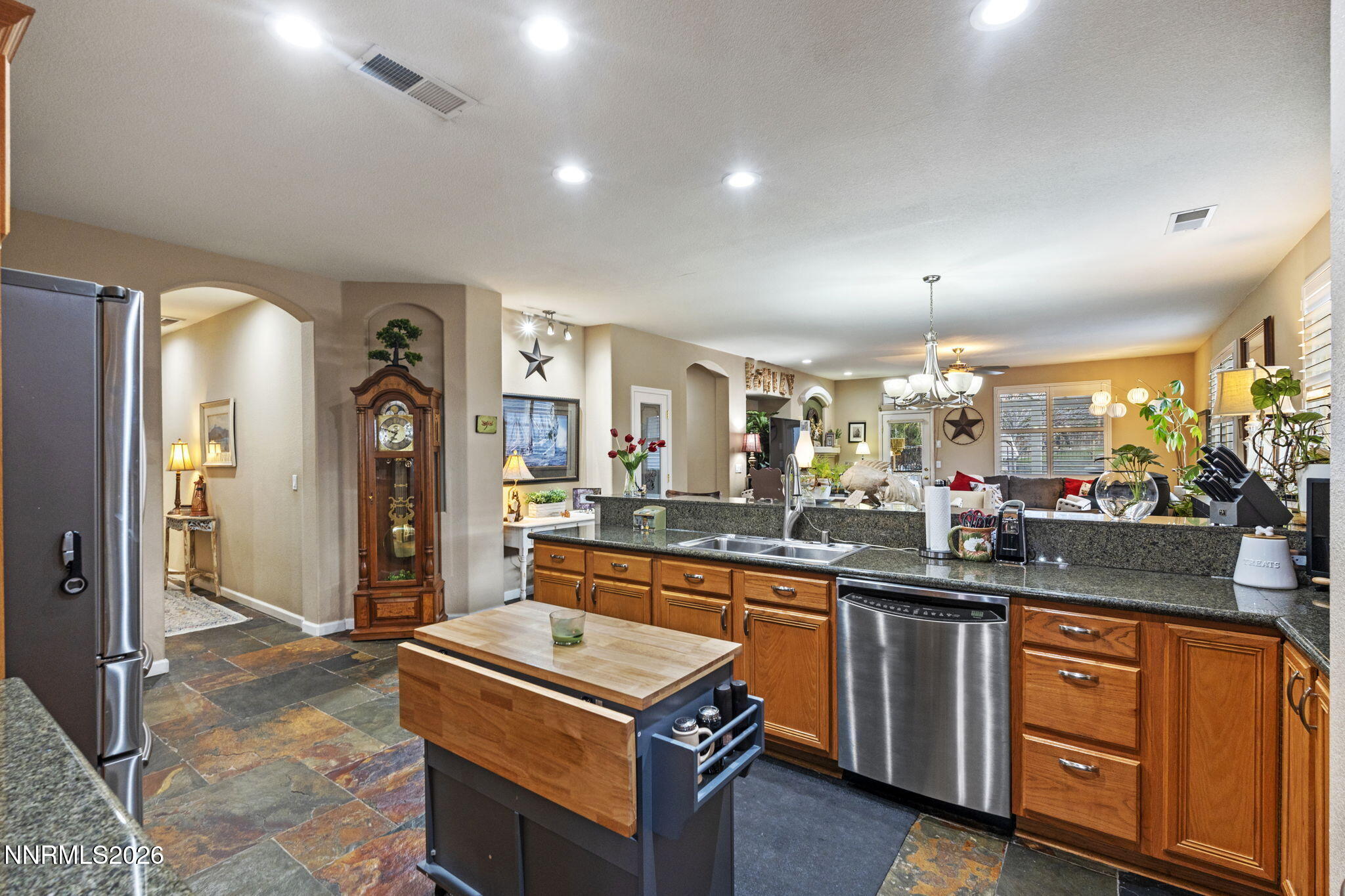 3239 Banestone Road Sparks, NV 89436 - Photo 11 of 38 a kitchen with stainless steel appliances granite countertop a stove a sink and a refrigerator