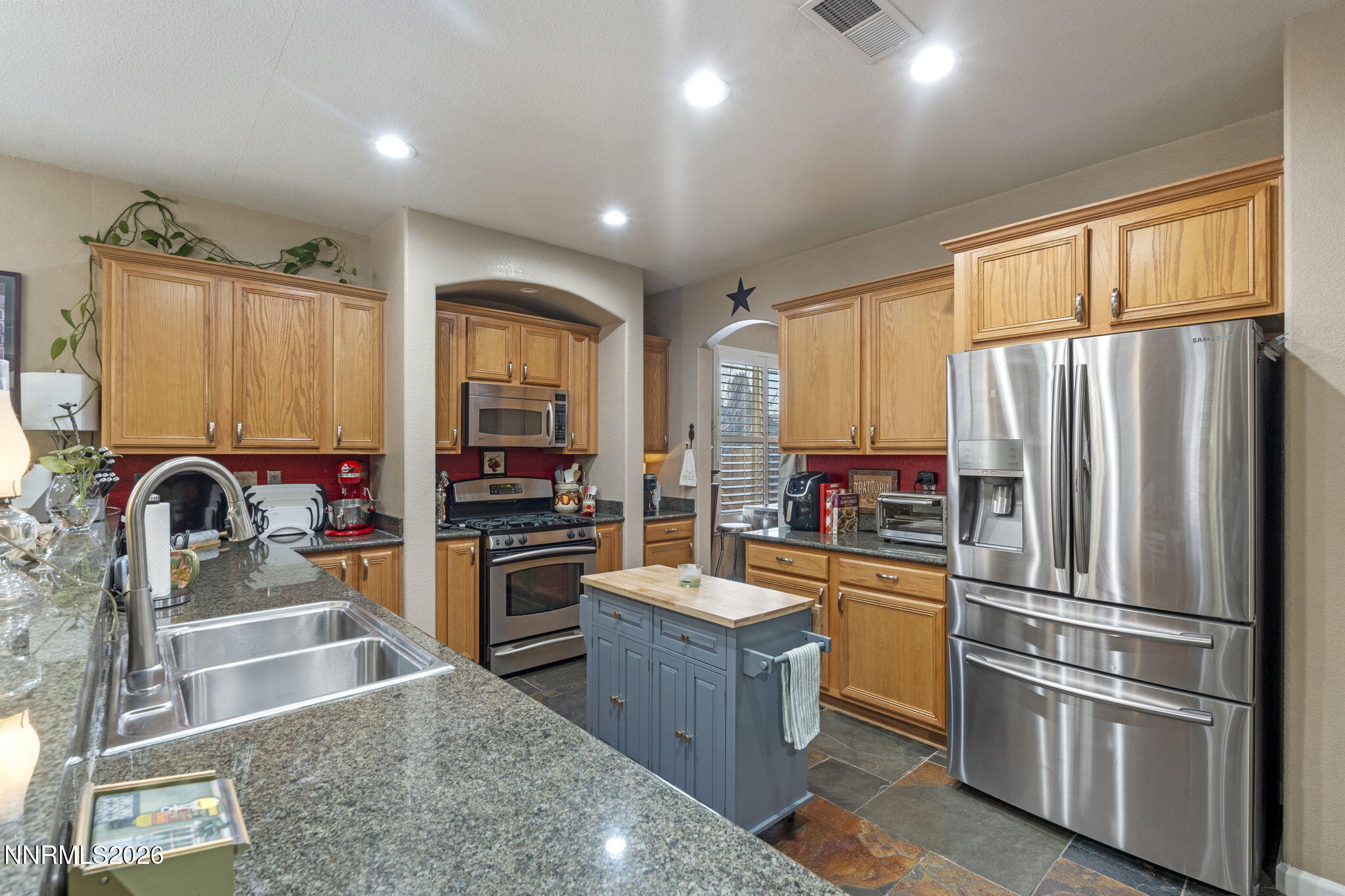 3239 Banestone Road Sparks, NV 89436 - Photo 9 of 38 a kitchen with stainless steel appliances granite countertop a refrigerator stove and sink