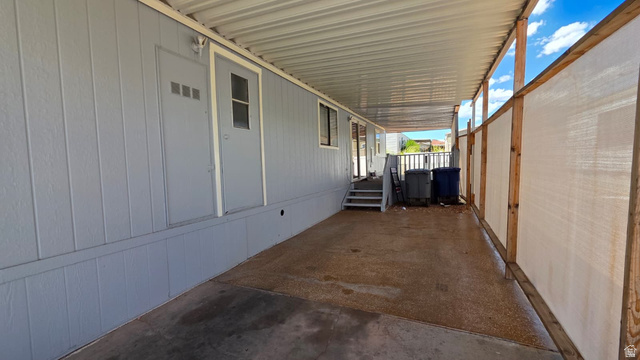 1450 North Dixie Downs Road, Unit 51 St. George, UT 84770 - Photo 16 of 25 Covered carport with light gray siding and two entry doors