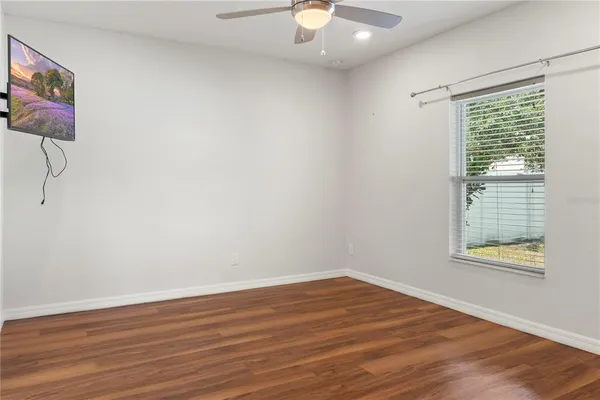 a view of a room with wooden floor and bench
